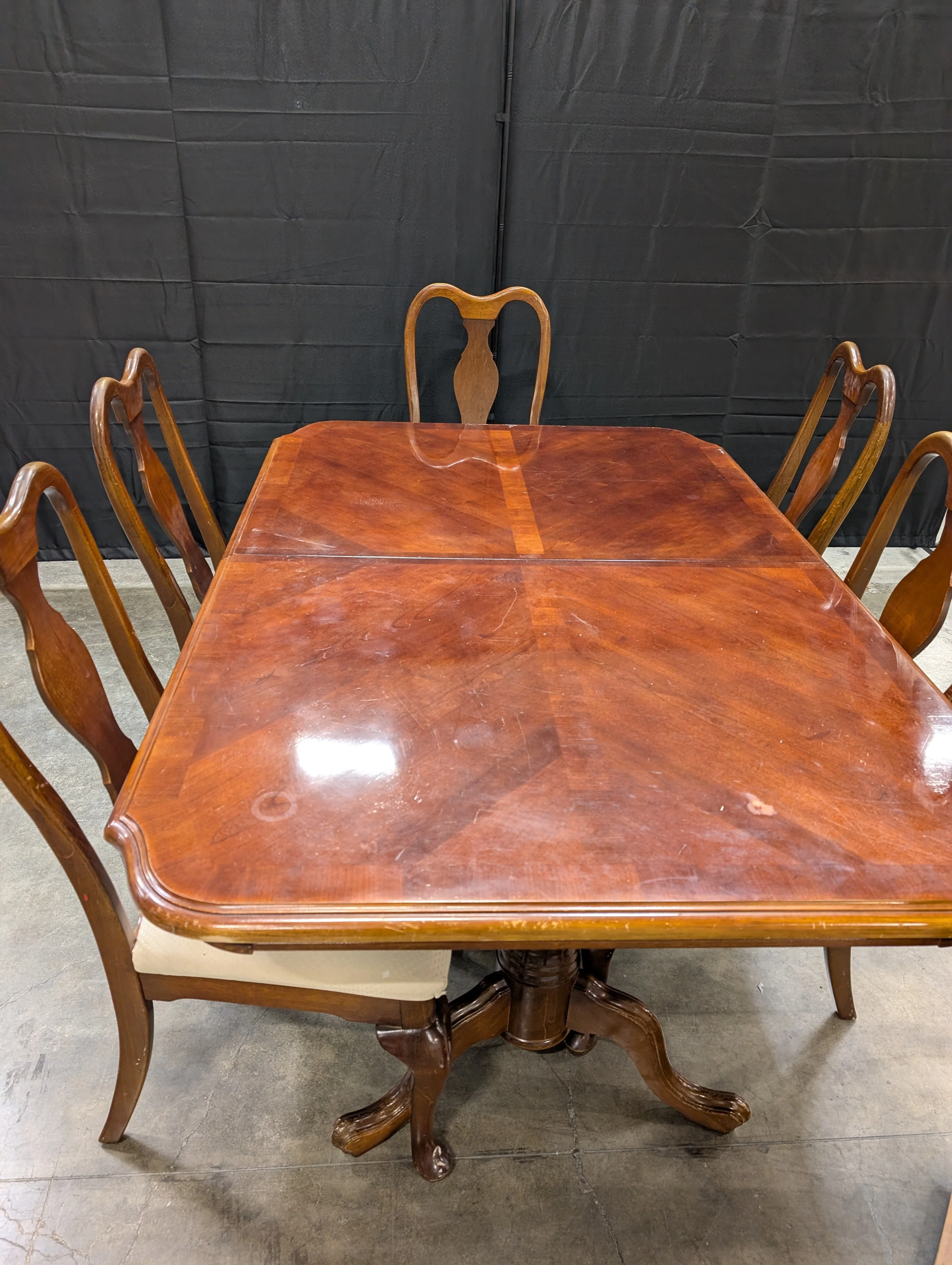 Traditional Dark Wood Dining Table with Five Shaped-Back Chairs