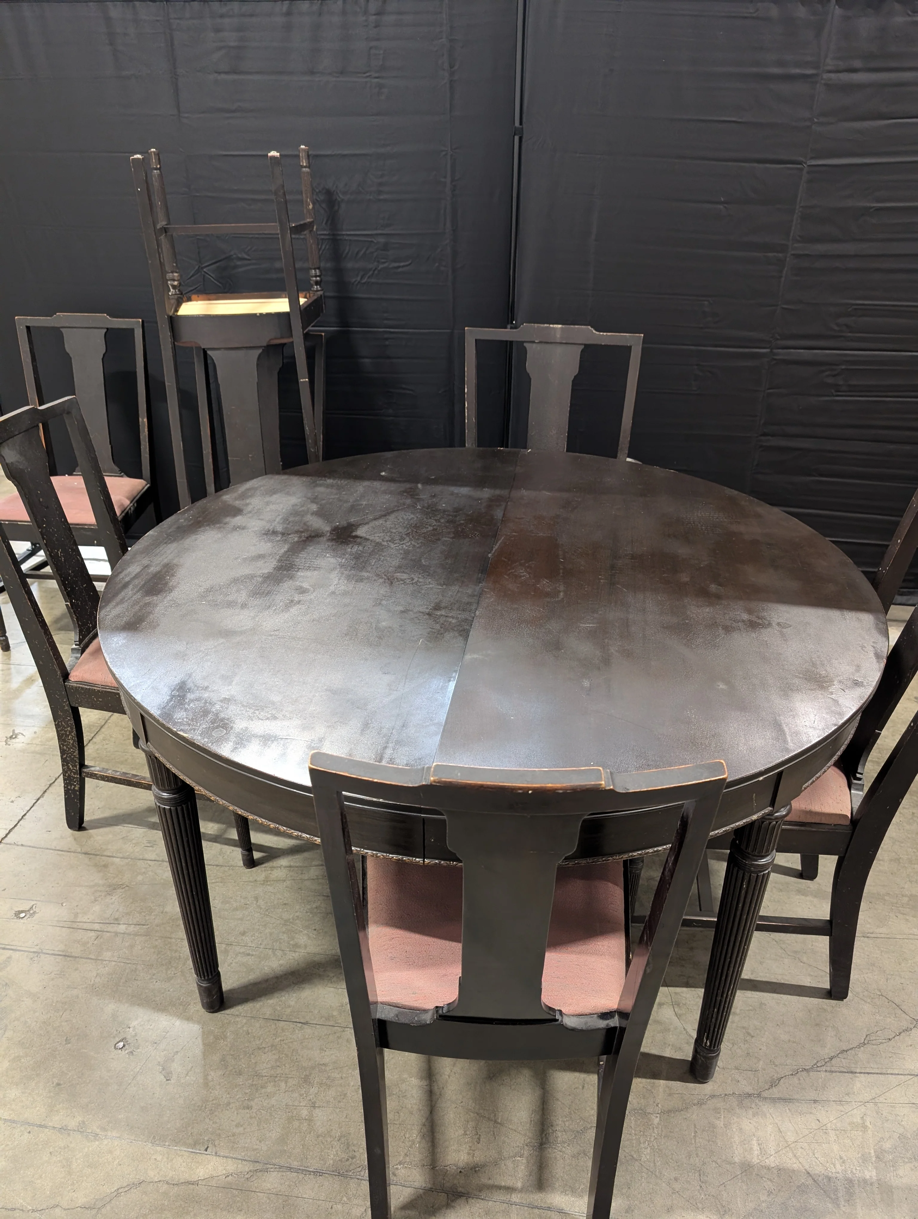 Dark Wood Oval Extendable Dining Table with Seven matching Chairs