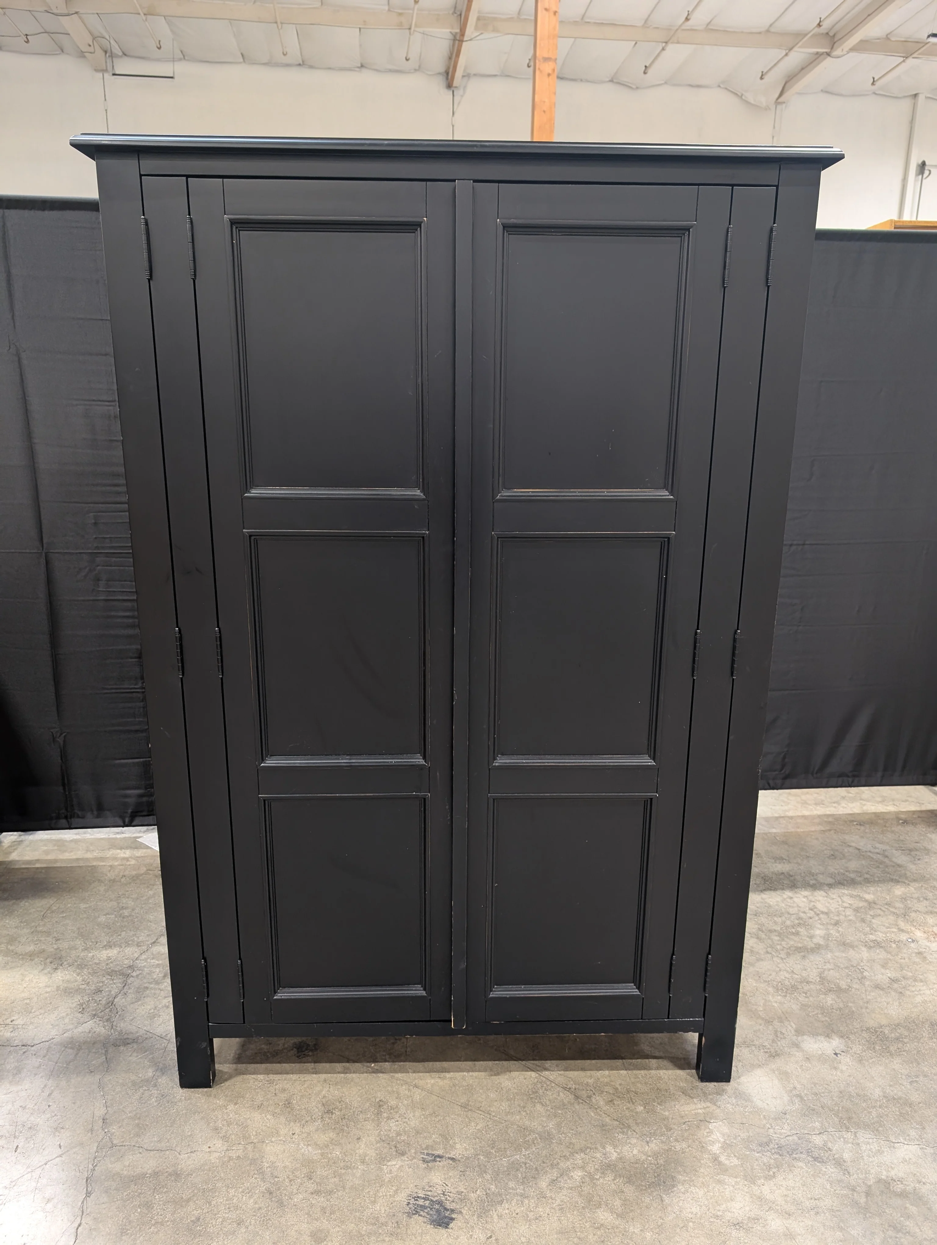 Versatile Black Wood Storage Armoire with Paneled Doors