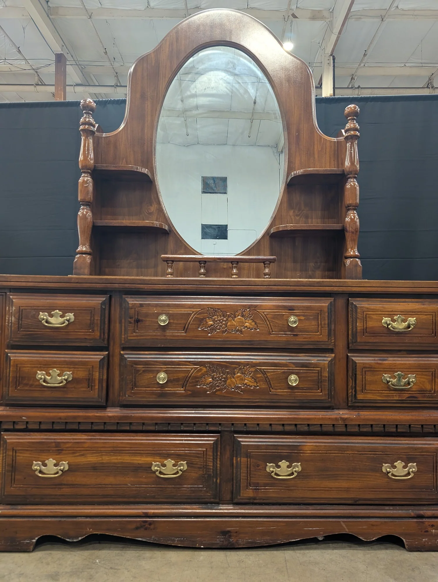 Traditional Dark Wood Dresser with Oval Mirror and Carved Accents