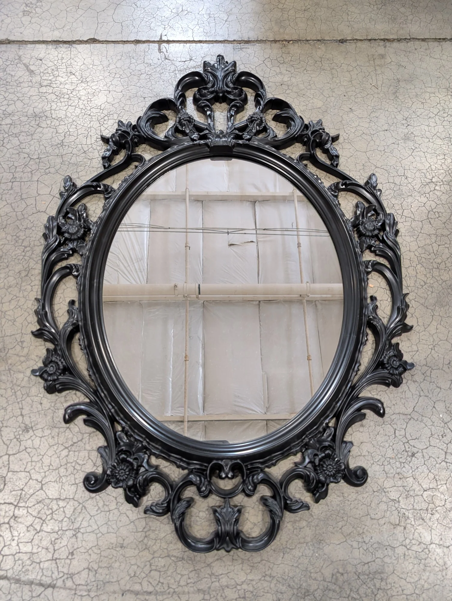 Ornate Black Oval Wall Mirror with Rococo-Inspired Plastic Frame