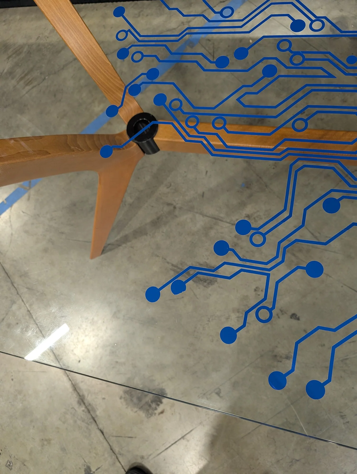 Modern Tech-Inspired Glass Top Dining Table with Splayed Wood Base - Image 4