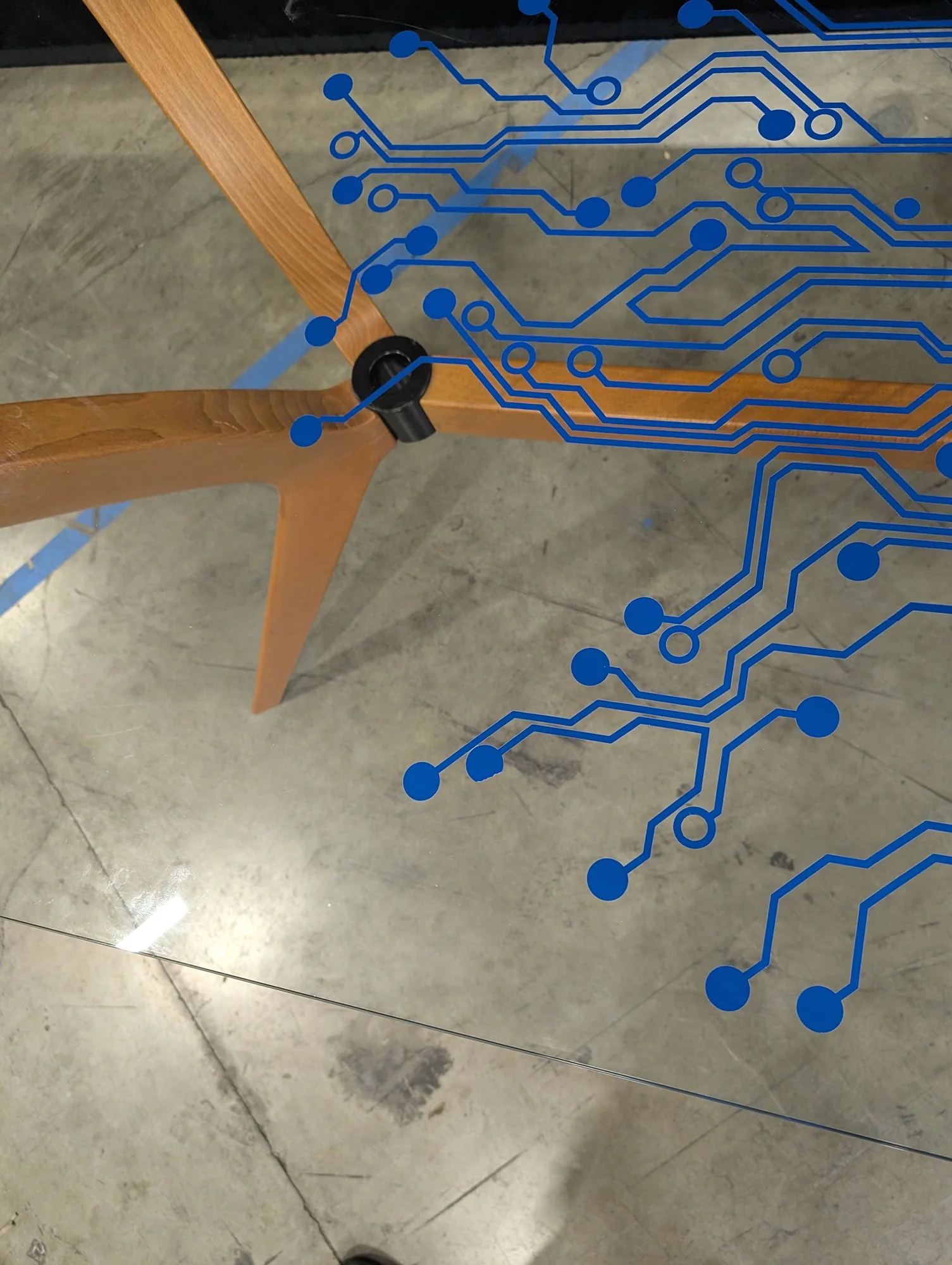 Modern Tech-Inspired Glass Top Dining Table with Splayed Wood Base - Image 5