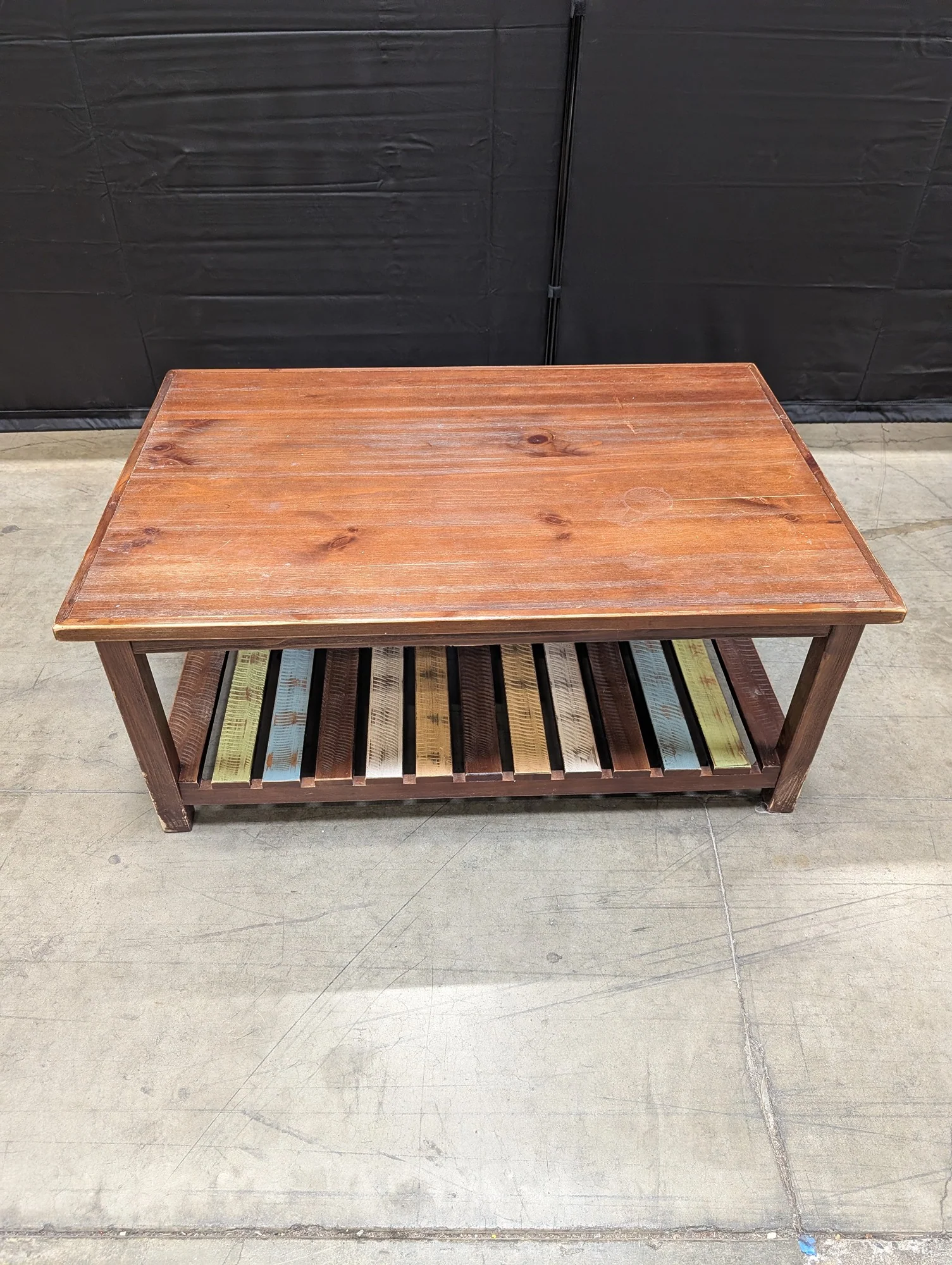 Rustic Wood Coffee Table with Multi-Color Slatted Shelf