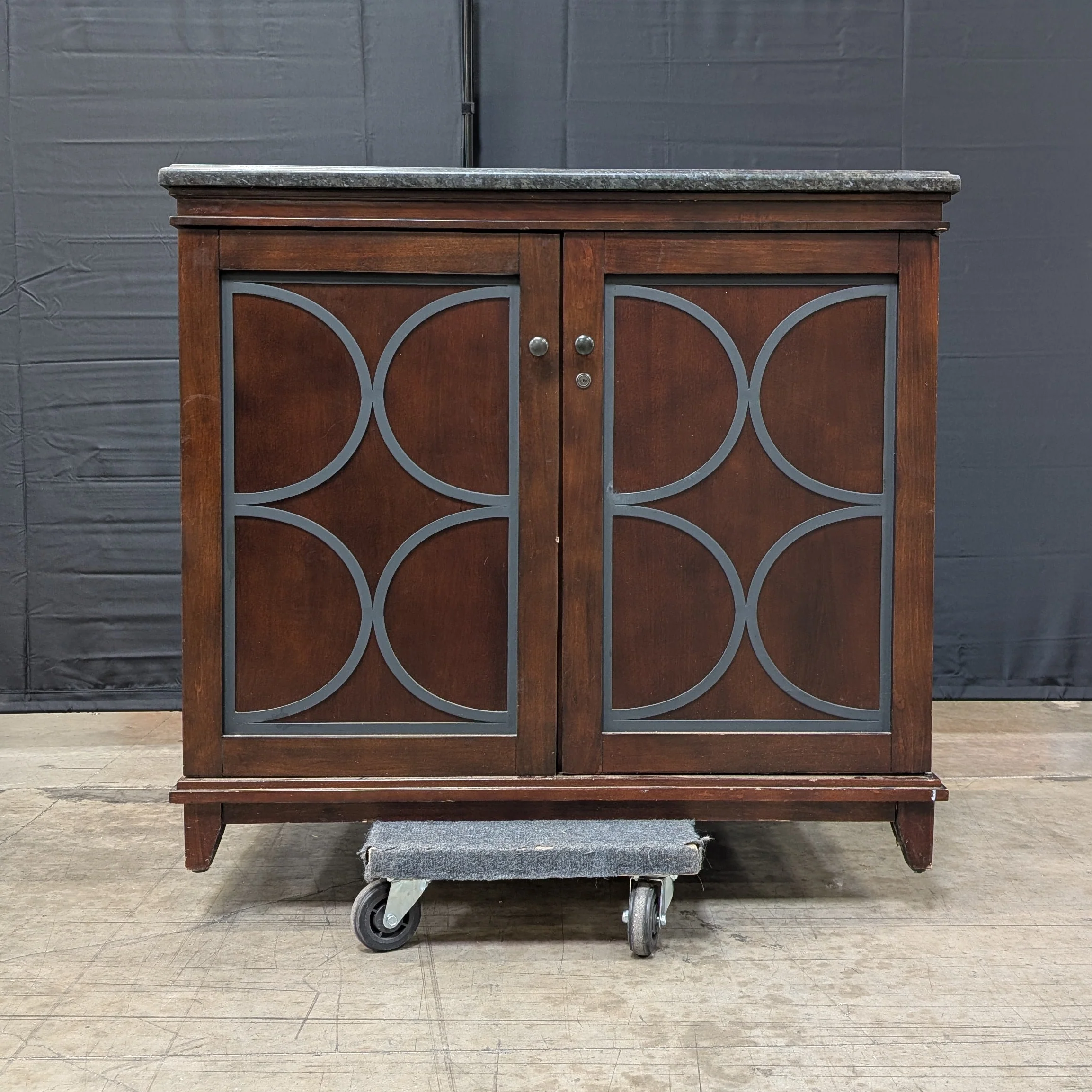 Dark Wood Storage Cabinet with Granite Top and Decorative Doors