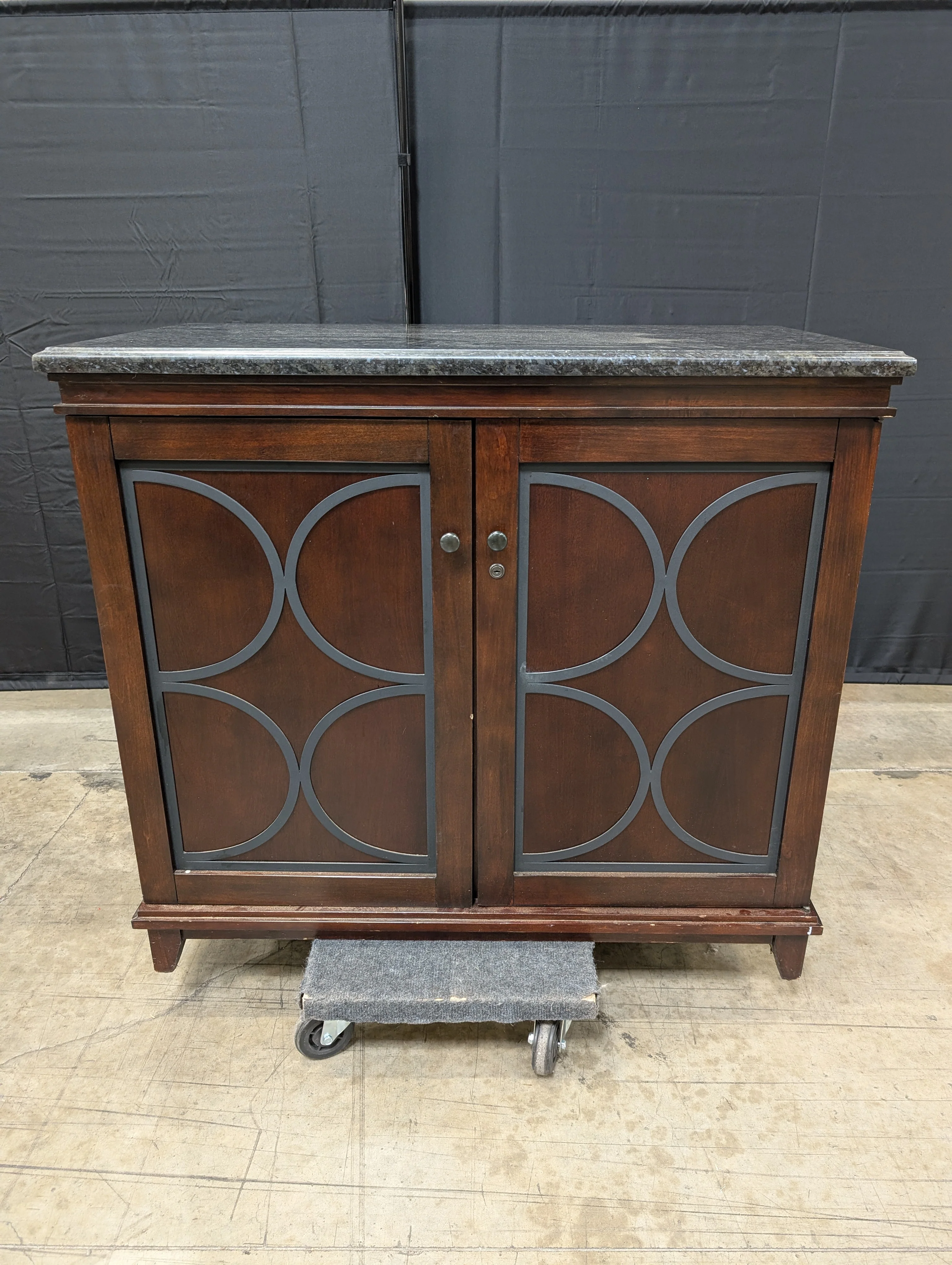 Dark Wood Storage Cabinet with Granite Top and Decorative Doors - Image 9